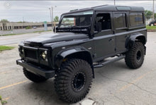 Load image into Gallery viewer, DA1968 - DEFENDER XS FRONT GRILLE AND HEADLAMP SURROUNDS IN BLACK WITH SILVER MESH
