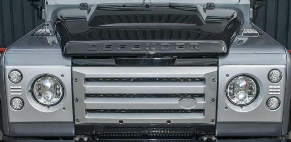 DEFENDER XS FRONT GRILLE AND HEADLAMP SURROUNDS IN SILVER WITH BLACK MESH