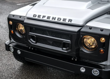 Load image into Gallery viewer, DEFENDER X-LANDER FRONT GRILLE &amp; HEADLIGHT SURROUNDS BY CHELSEA TRUCK CO.
